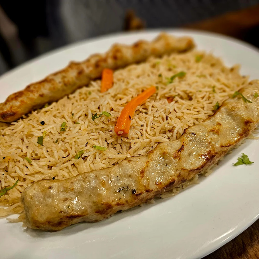 Grilled seekh kebabs served with aromatic rice platter