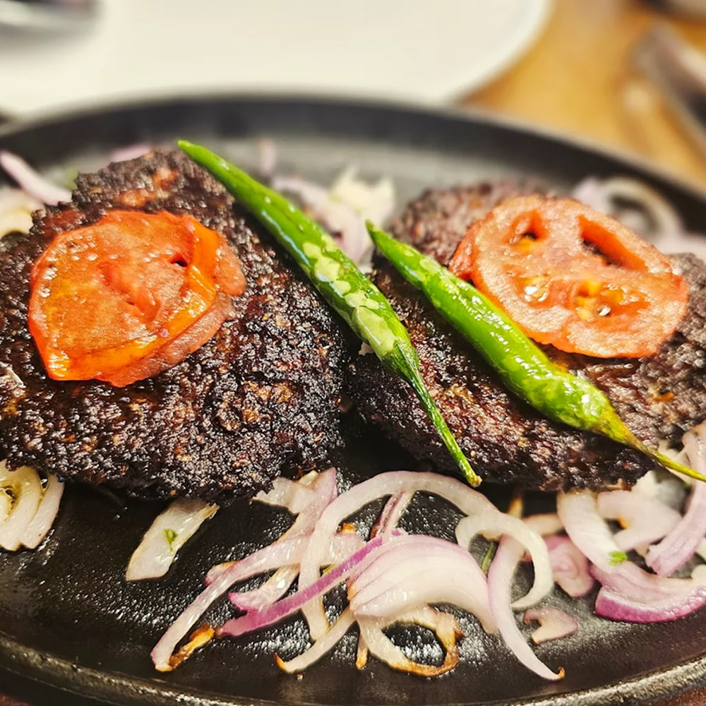 Spicy grilled kebabs served with onions and green chilies