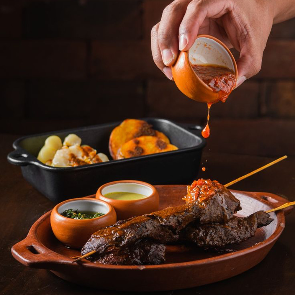 Grilled Arabic kebabs served with sauce and roasted vegetables
