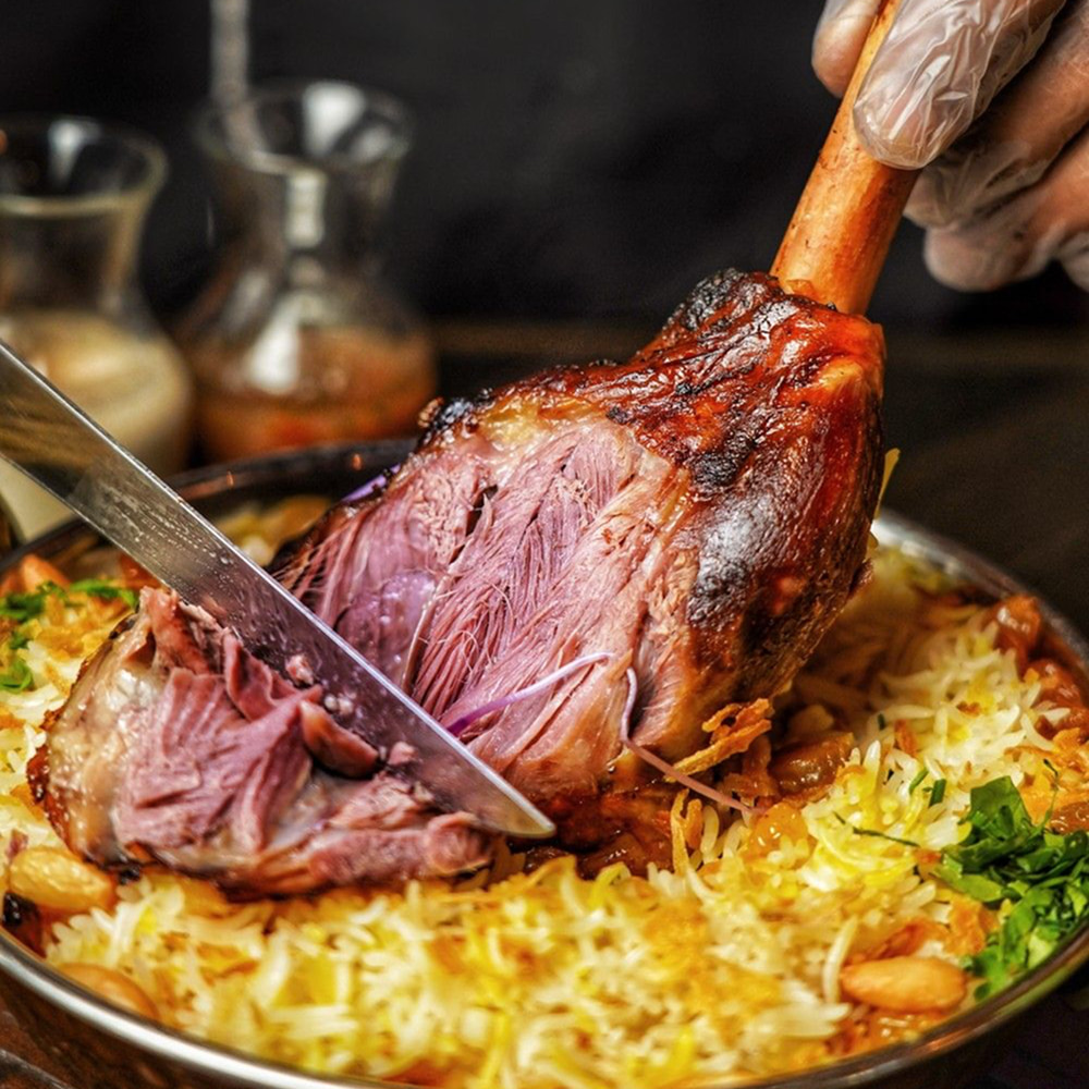 Roasted Arabic lamb served over fragrant rice platter
