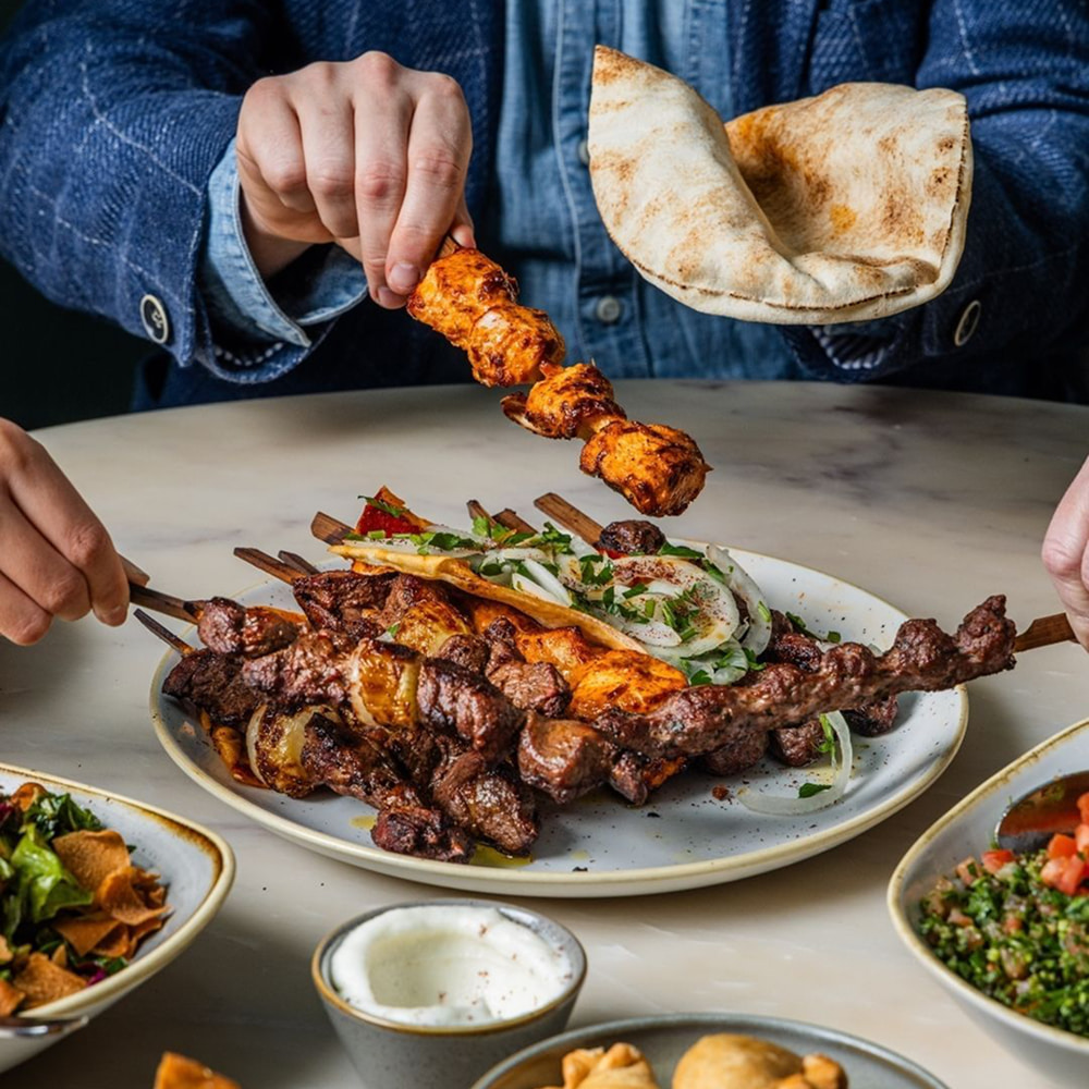 Mixed Arabic kebabs served with pita bread and salad