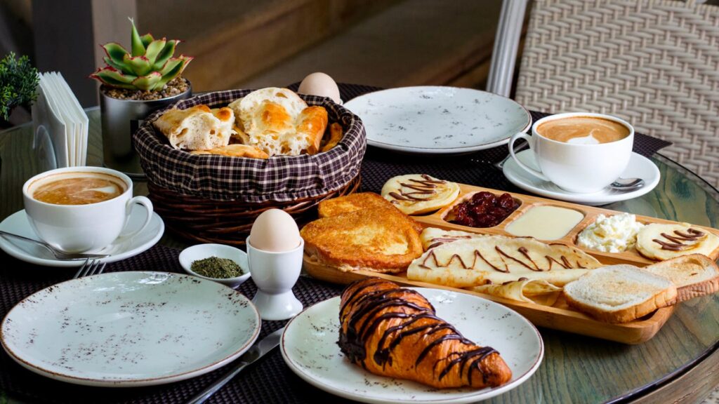 Continental breakfast spread with coffee, pastries, and toast