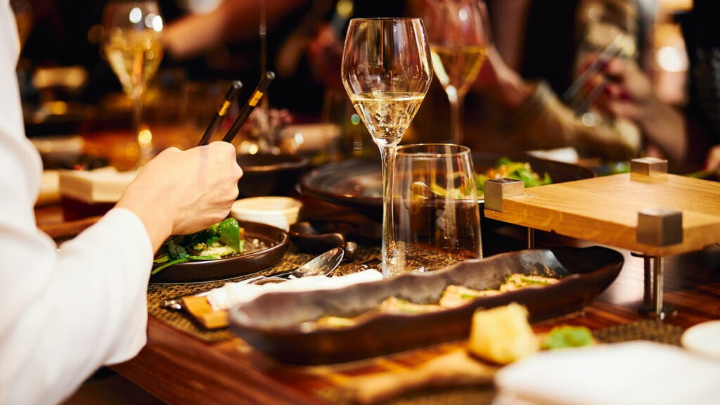 Elegant fine dining table setup with food and wine