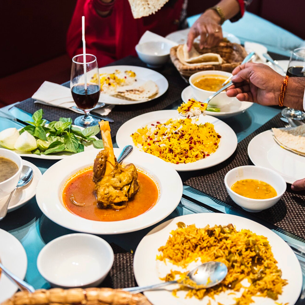 Traditional Indian family dinner served with curries and biryani