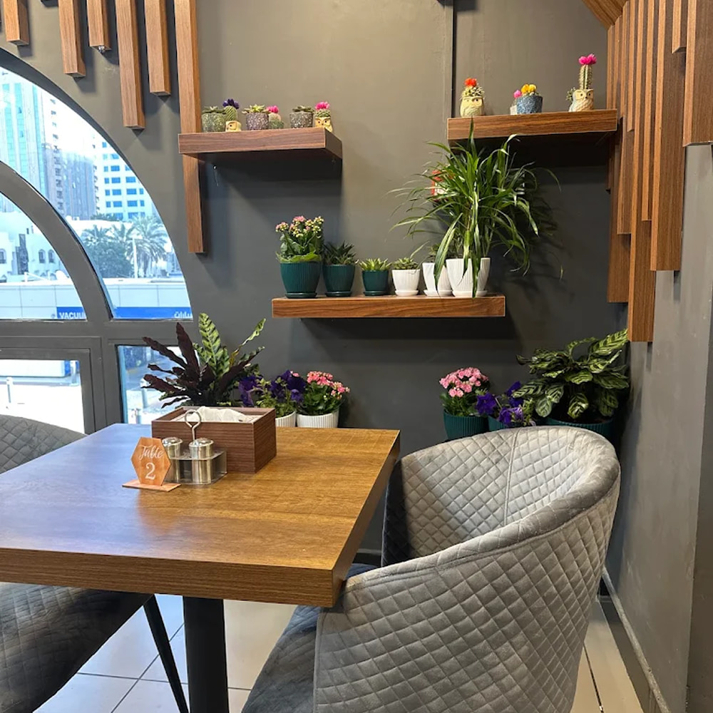Modern restaurant interior with cozy seating and floral decor