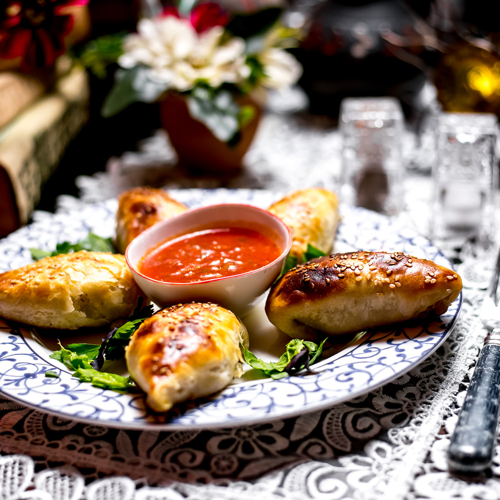 Crispy stuffed pastries served with spicy dipping sauce