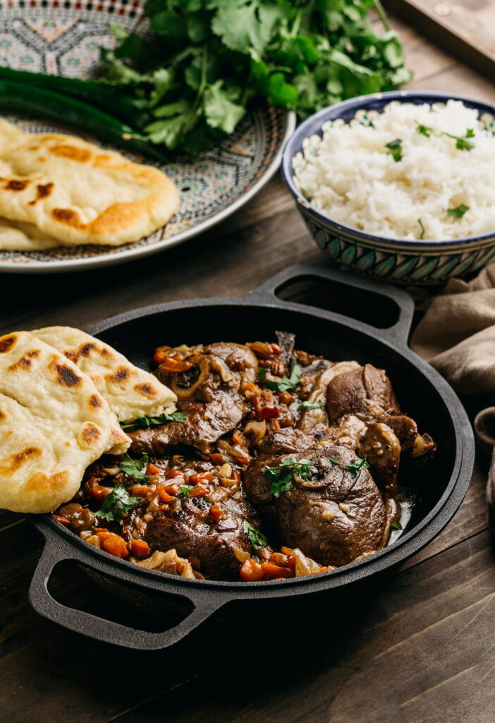 Slow cooked beef curry served with rice and naan