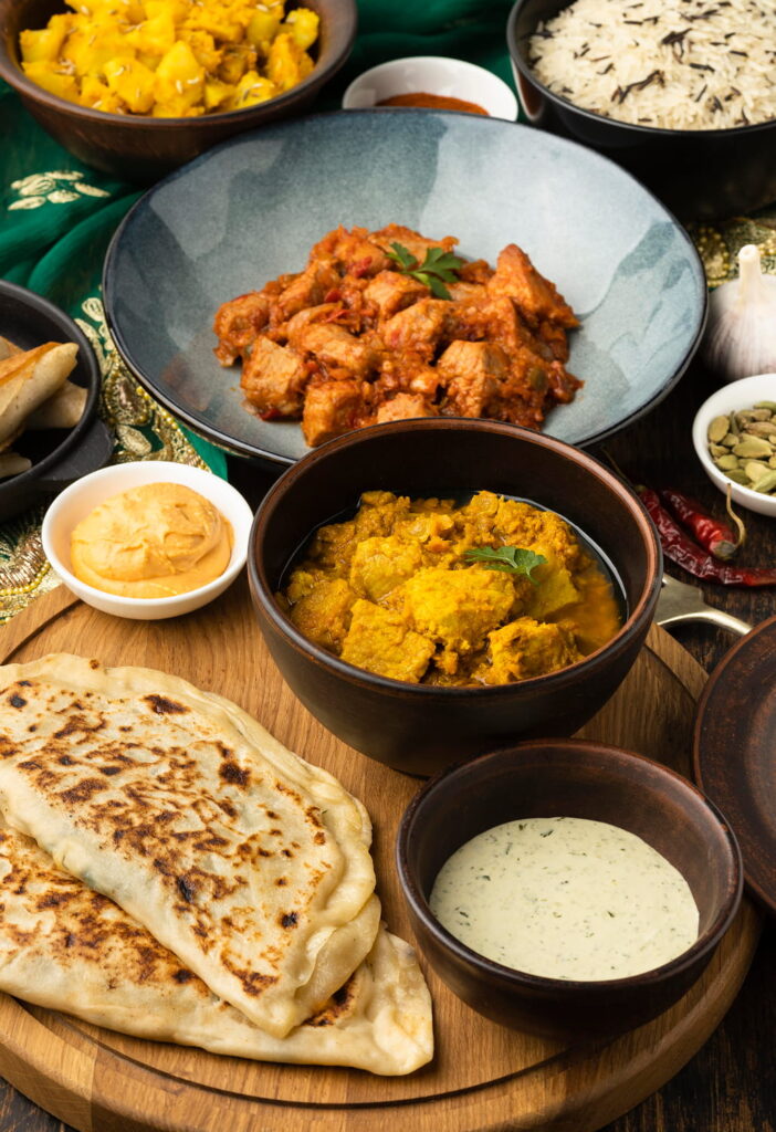 Authentic curry platter served with naan and creamy sauce