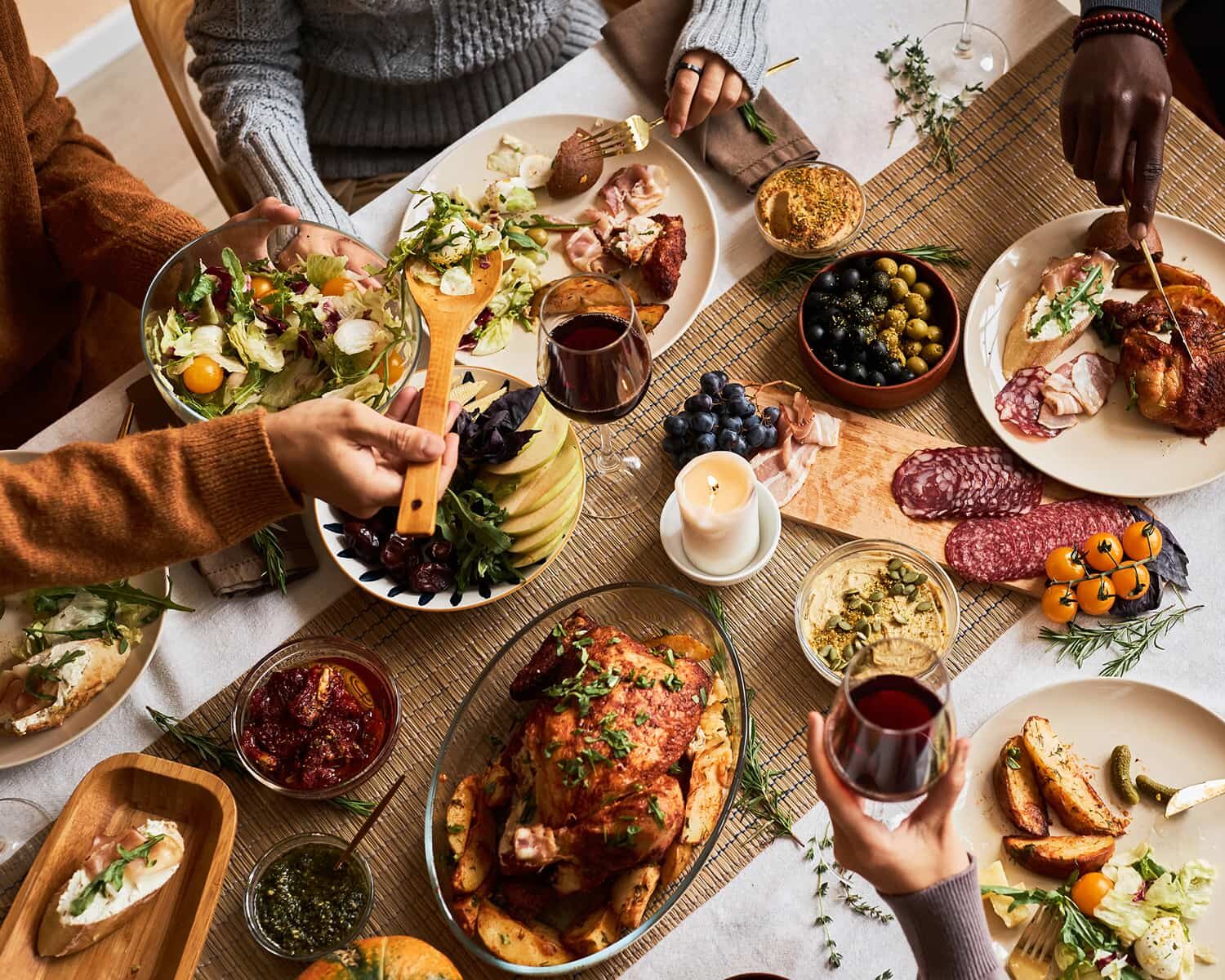 Family dinner table with roasted chicken and fresh dishes
