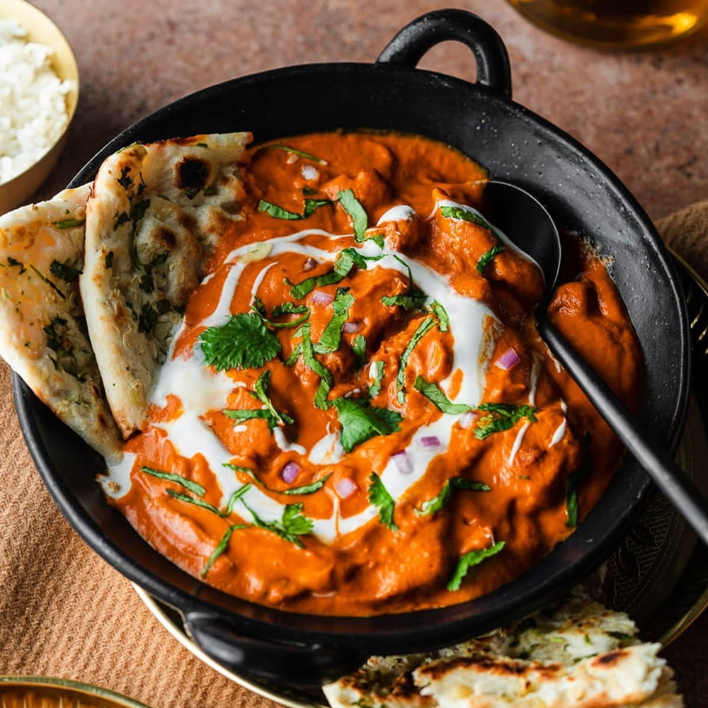 Creamy chicken tikka masala served with garlic naan bread