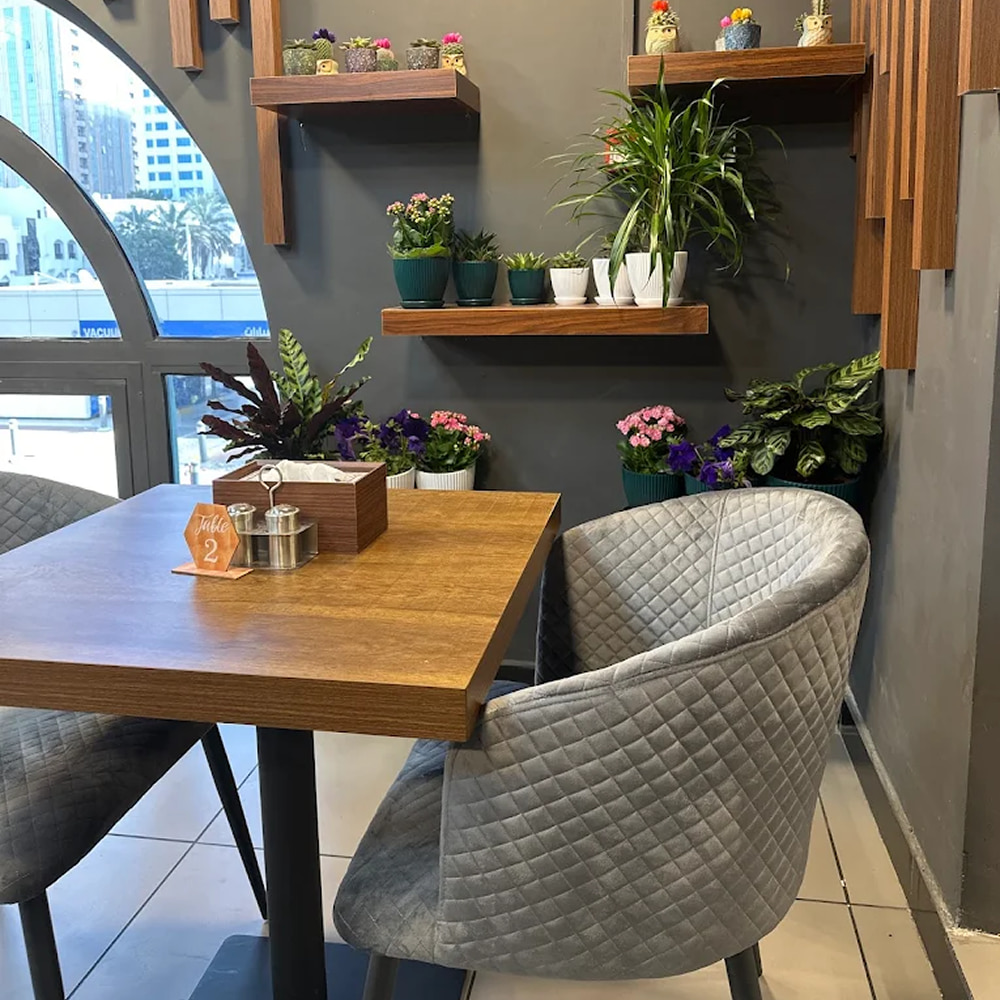Modern restaurant seating area with plants and wooden decor