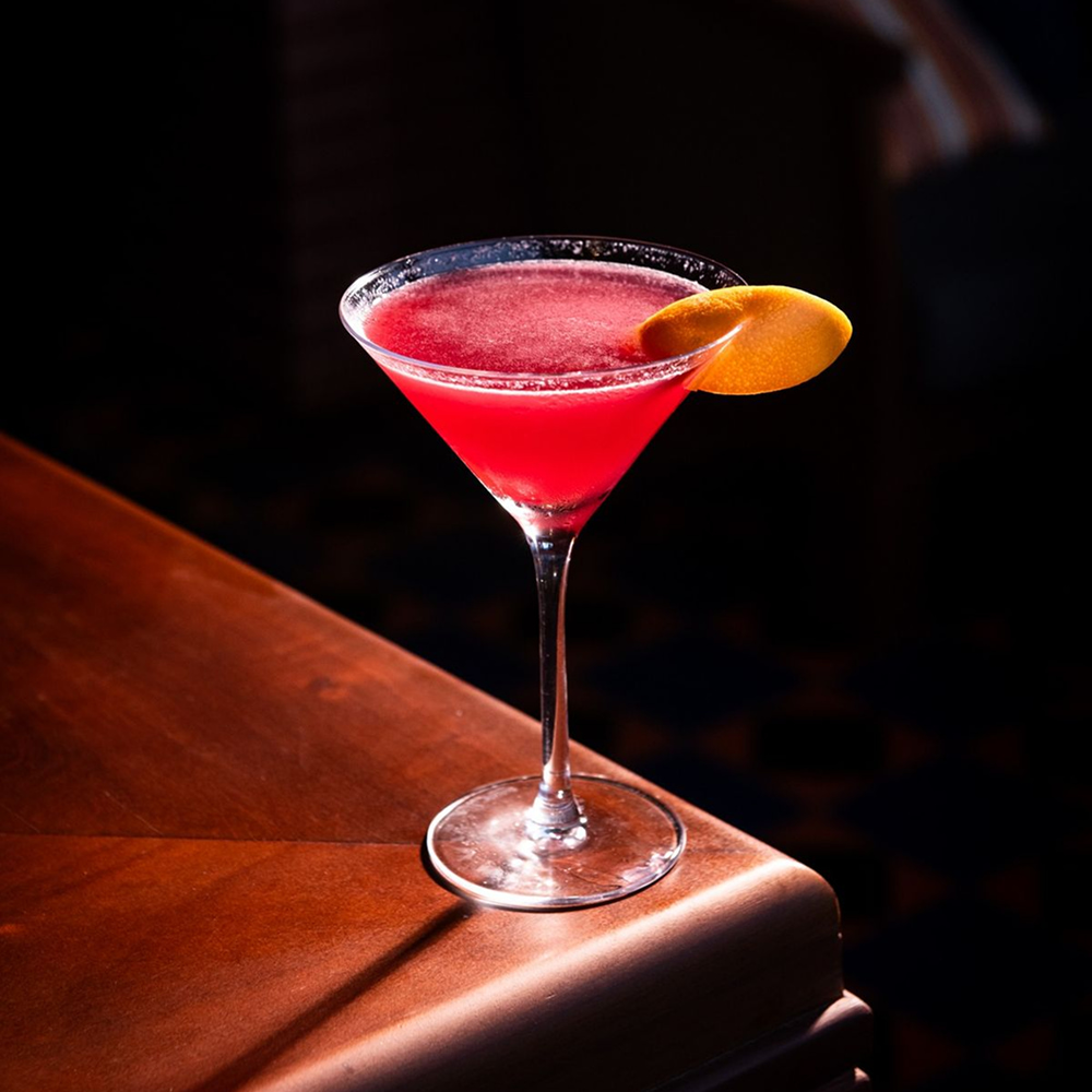 Refreshing red cocktail served in elegant martini glass