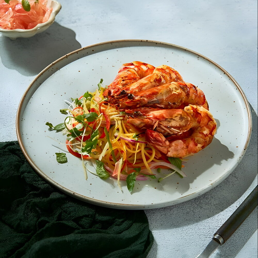 Grilled prawns served with fresh vegetable pasta salad