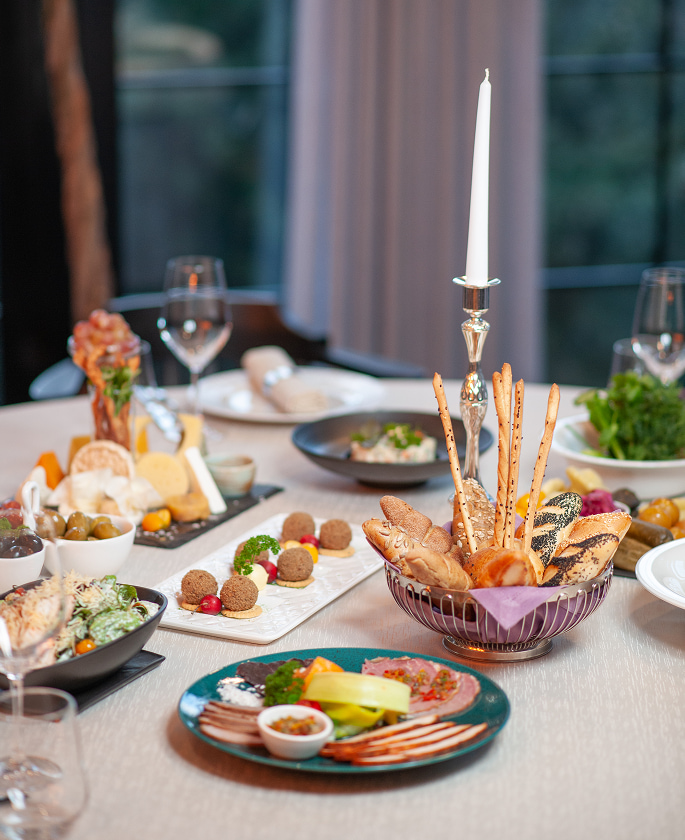 Elegant dining table setup with appetizers and candle centerpiece