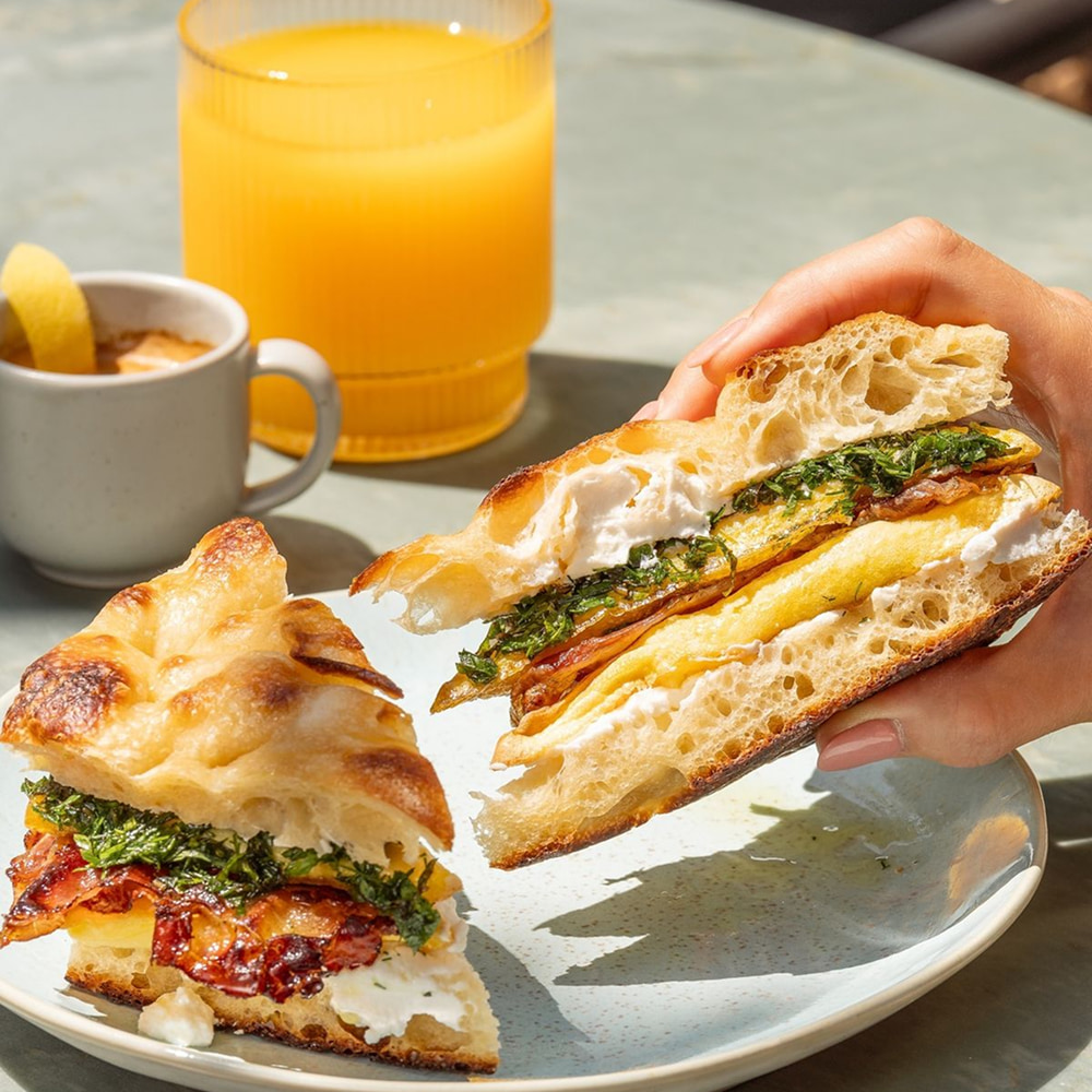Breakfast sandwich served with orange juice and coffee